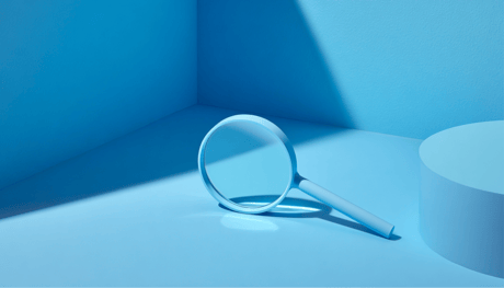 Magnifying glass against blue background to represent MMM granularity trap.