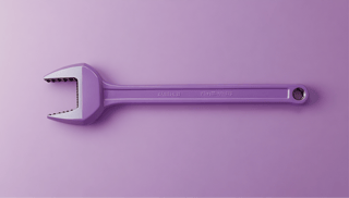 A pipe wrench resting on a surface, symbolizing the unseen burdens of building marketing data pipelines in-house 