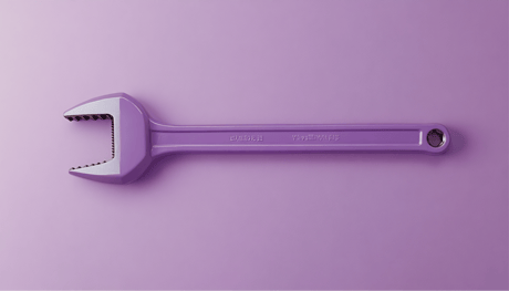 A pipe wrench resting on a surface, symbolizing the unseen burdens of building marketing data pipelines in-house