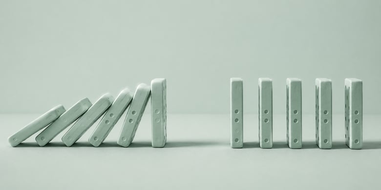 Minimalist row of dominoes with a deliberate gap preventing the chain reaction from continuing