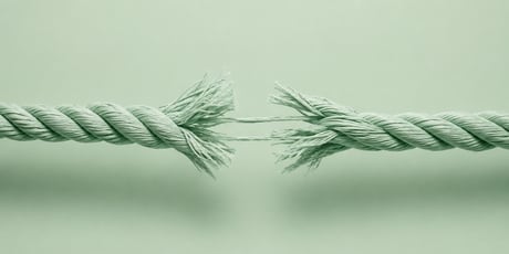 Thick rope pulled from opposite directions with fibers beginning to snap at the center | photorealistic