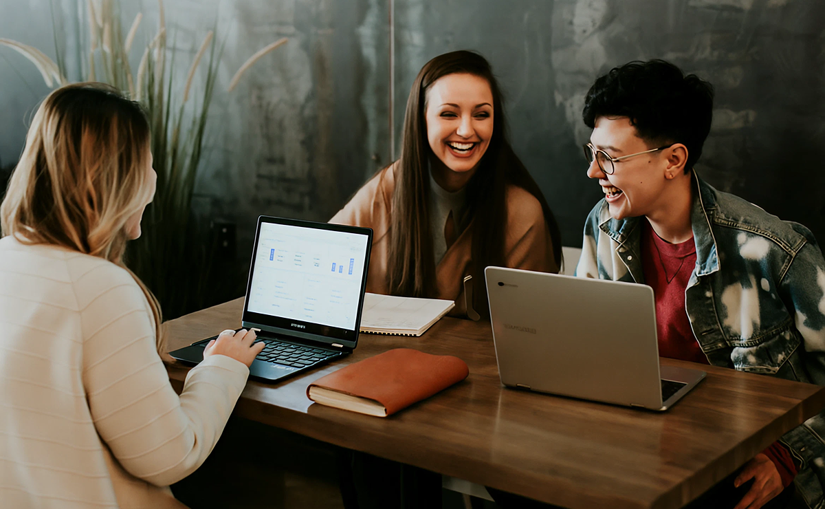 Happy people using laptops